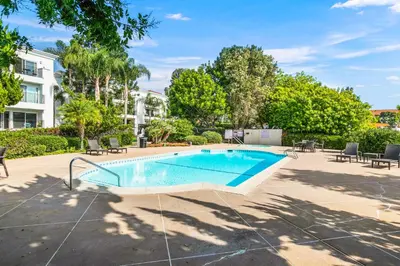 a swimming pool with chairs and a building at 647 Luxury Inside The Gates LaCosta Resort-Top Floor Steps from Resort 647 in Encinitas