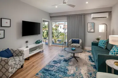 a living room with a couch and a tv at 645 Fresh Modern Condo Inside Resort Gates - Free Wifi - Walk to Spa in Encinitas