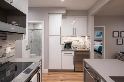a kitchen with white cabinets and a counter top at 645 Fresh Modern Condo Inside Resort Gates - Free Wifi - Walk to Spa in Encinitas