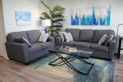 a living room with two couches and a coffee table at 207A Fresh, Renovated and Steps from the Beach in Oceanside
