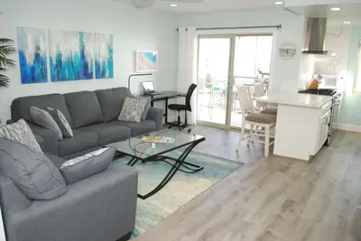 a living room with a couch and a table at 207A Fresh, Renovated and Steps from the Beach in Oceanside
