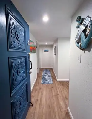 a hallway with a blue door in a house at 209A Beach Living at its Best in Oceanside