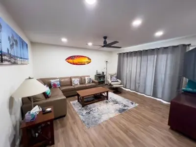 a living room with a couch and a table at 209A Beach Living at its Best in Oceanside