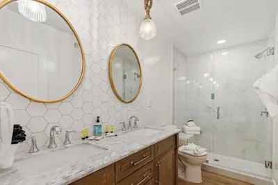 a bathroom with a sink and a mirror and a toilet at 211A Freshly Renovated Steps from the Sand at the Beach Oceanside in Oceanside