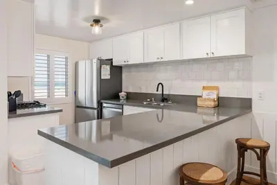 a kitchen with white cabinets and a counter top at 211A Freshly Renovated Steps from the Sand at the Beach Oceanside in Oceanside