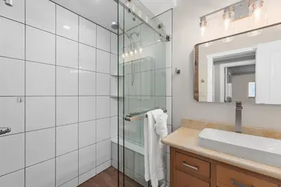 a bathroom with a glass shower and a sink at 211B - Harbor, Seals, Birds, Night Lights, Steps to the Sand! in Oceanside