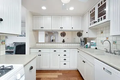 a white kitchen with white cabinets and a sink at 212A Beachfront View-Free Wifi in Oceanside