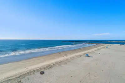 an empty beach with the ocean on a sunny day at 212A Beachfront View-Free Wifi in Oceanside