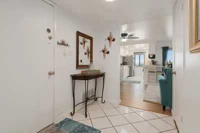 a hallway with a table and a living room at 214A - Beach and Water View, Steps to the Sand in Oceanside