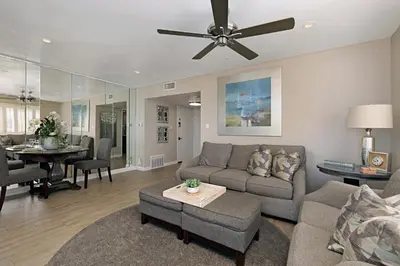 a living room with a couch and a ceiling fan at 215A - Beautiful Sunsets, Beach View, Free Wifi in Oceanside