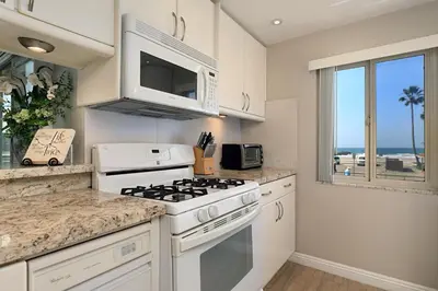 a kitchen with a stove and a microwave at 215A - Beautiful Sunsets, Beach View, Free Wifi in Oceanside