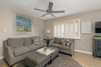 a living room with a couch and a ceiling fan at 215A - Beautiful Sunsets, Beach View, Free Wifi in Oceanside