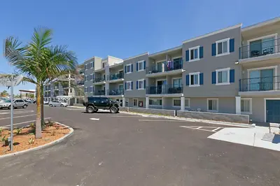 a car parked in a parking lot in front of a building at 215A - Beautiful Sunsets, Beach View, Free Wifi in Oceanside