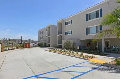 an empty sidewalk in front of a building at 301B Ocean Harbor View - Top Floor Corner Unit in Oceanside