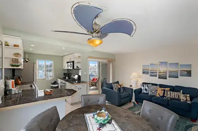 a living room with a couch and a table at 301B Ocean Harbor View - Top Floor Corner Unit in Oceanside