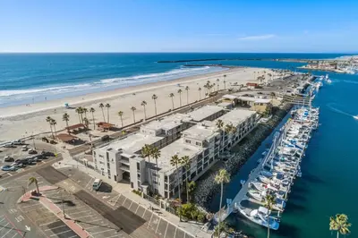 an aerial view of a marina and the beach at 303B Perfect Location Beach Across the Street - Walk to Shops Dining - Harbor Views in Oceanside