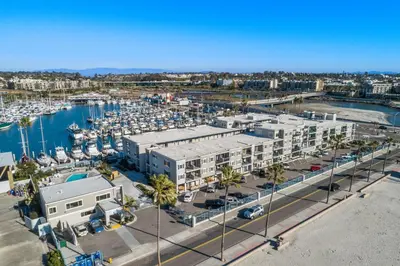 an aerial view of a marina with buildings and boats at 305B - Seaside at the Marina - 100 Steps to the Sand in Oceanside