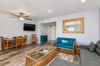 a living room with a couch and a table at 308B - Beautiful Harbor Ocean Retreat in Oceanside