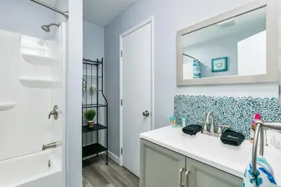a bathroom with a sink and a mirror at 308B - Beautiful Harbor Ocean Retreat in Oceanside