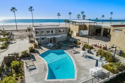 an aerial view of a house with a swimming pool and the beach at 309A - Ocean and Beach View in Oceanside