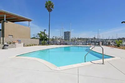 a large swimming pool in a parking lot at 311B Harbor Views and Steps to the Sand in Oceanside