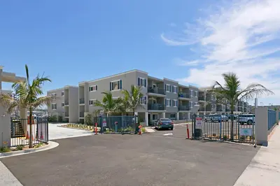 a parking lot in front of a apartment complex at 401B Marina Del Mar Penthouse Harbor & Ocean View in Oceanside
