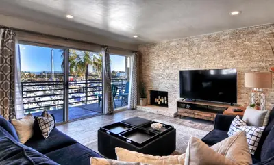 a living room with a couch and a tv at 401B Marina Del Mar Penthouse Harbor & Ocean View in Oceanside