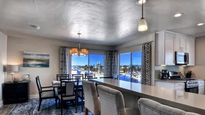a kitchen and dining room with a table and chairs at 401B Marina Del Mar Penthouse Harbor & Ocean View in Oceanside