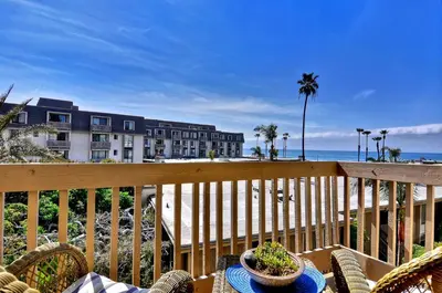 a balcony with a view of a hotel and the beach at Tropical Water View at North Coast Village C200 in Oceanside