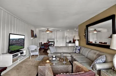 a living room with a couch and a television at Tropical Water View at North Coast Village C200 in Oceanside