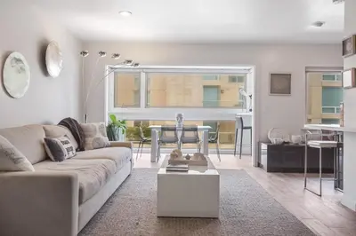 a living room with a couch and a table at Beachfront Oasis - 30-Night Minimum in San Diego
