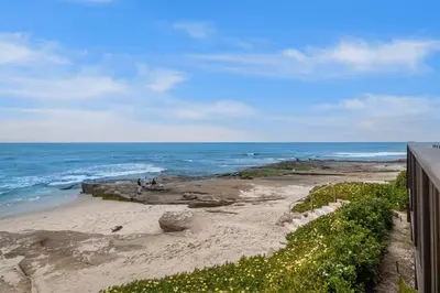 a view of the ocean from a balcony of a beach at Beachfront Oasis - 30-Night Minimum in San Diego