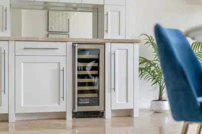 a kitchen with a dishwasher in a white kitchen at Water and sunset views in dreamy Cardiff by the sea in Encinitas