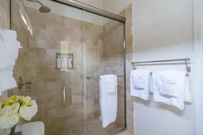 a shower with white towels in a bathroom at Water and sunset views in dreamy Cardiff by the sea in Encinitas