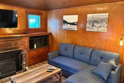 a living room with a blue couch and a tv at Julian Orchard Ranch in Santa Ysabel