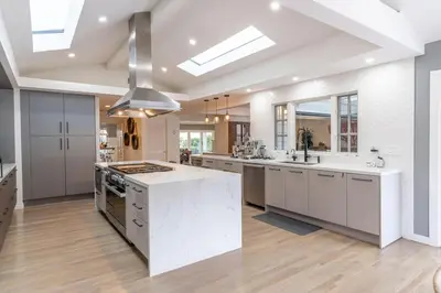 a large kitchen with white cabinets and a kitchen island at Walk to Beach Stunning Views La Jolla Shores in San Diego