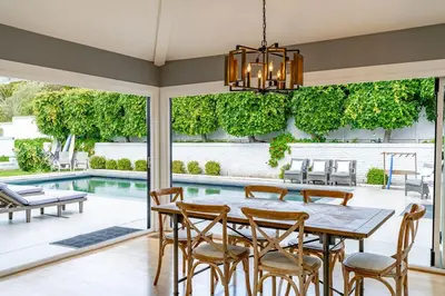 a dining room with a table and chairs and a pool at Walk to Beach Stunning Views La Jolla Shores in San Diego