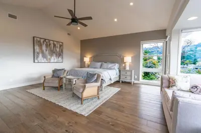 a bedroom with a bed and a couch at Walk to Beach Stunning Views La Jolla Shores in San Diego