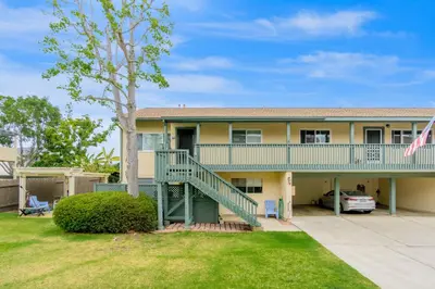 a house with a staircase and a yard at Juniper Coastal Home - 30-Night Minimum in Carlsbad