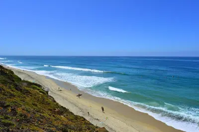 a group of people on a beach near the ocean at Juniper Coastal Home - 30-Night Minimum in Carlsbad