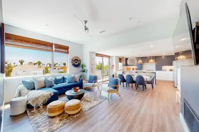 a living room with a blue couch and a table at Seaside Serenity Retreat in Oceanside