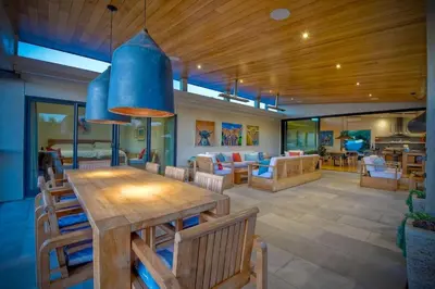 a dining room with a large wooden table and chairs at Bali Hai, Luxury, High-End Encinitas Home, Large Outdoor Living Area in Encinitas