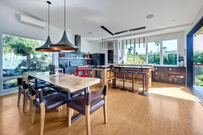 a kitchen with a table and some chairs in a room at Bali Hai, Luxury, High-End Encinitas Home, Large Outdoor Living Area in Encinitas