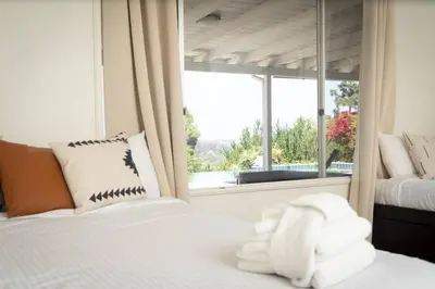 a bedroom with two beds and a large window at Modern Luxury in Bonita - 2655sqft with Infinity Pool in Bonita