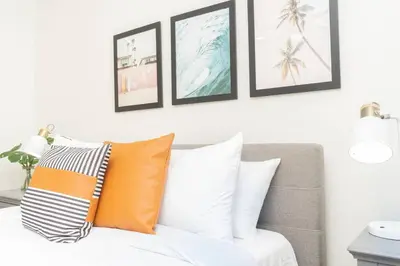 a room with a couch with orange and white pillows at Modern Luxury in Bonita - 2655sqft with Infinity Pool in Bonita