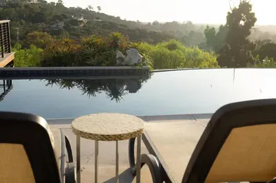 a balcony with a table and a view of a pool at Modern Luxury in Bonita - 2655sqft with Infinity Pool in Bonita