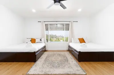 two beds in a room with a window at Modern Luxury in Bonita - 2655sqft with Infinity Pool in Bonita