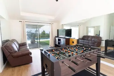 a living room with a large foosball table at Modern Luxury in Bonita - 2655sqft with Infinity Pool in Bonita