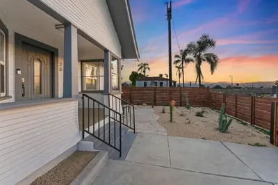 a porch of a house with a sunset in the background at Sundown Sanctuary in National City in National City