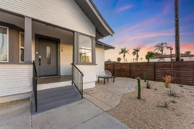 a house with a porch with a bench on it at Sundown Sanctuary in National City in National City